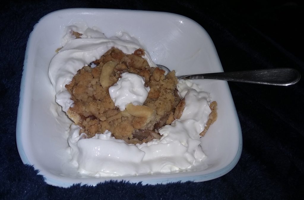 slice of pie with whipped cream in a bowl with spoon